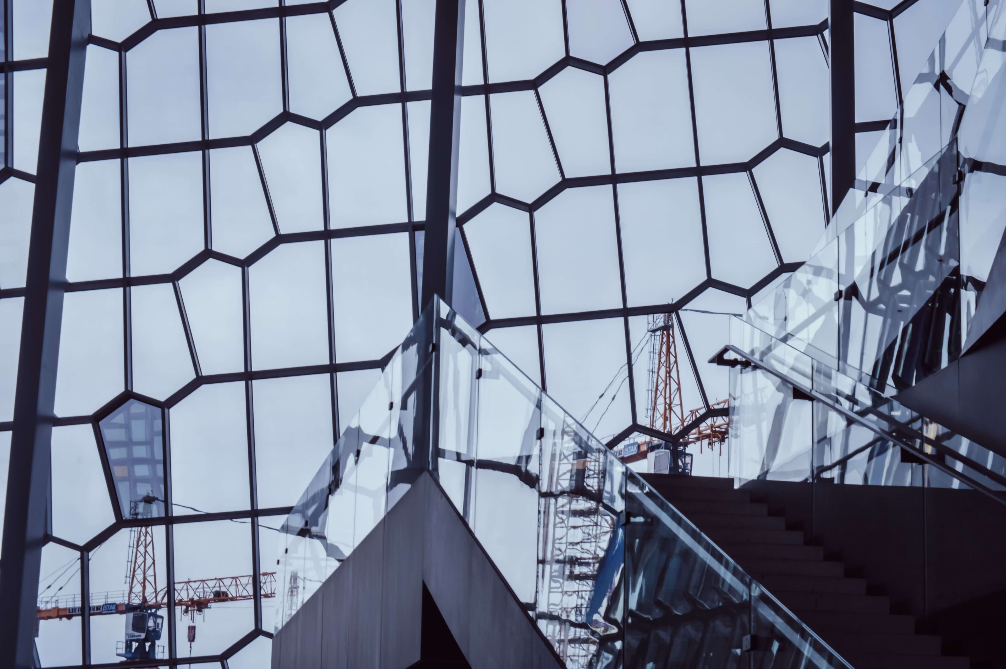 corporate building with cranes in the distance